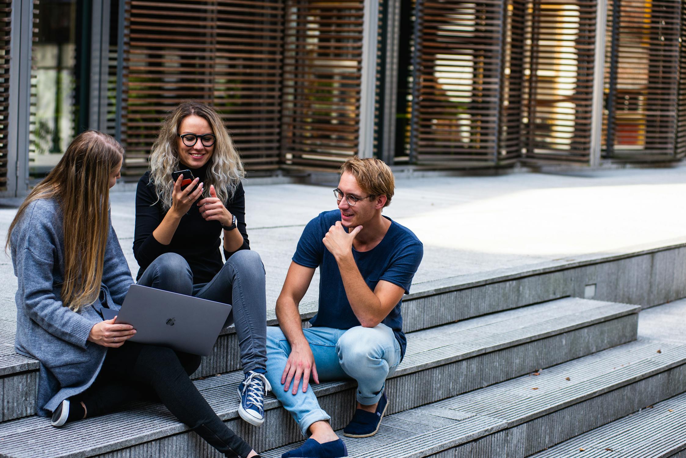 College students sitting and smiling