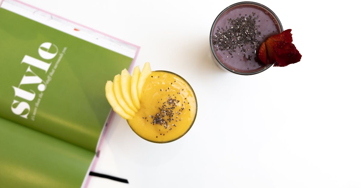 Top view of vibrant mango and berry smoothies garnished with chia seeds, perfect for a healthy treat.