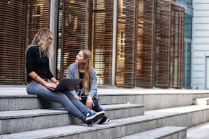 Two Women Having Conversation on Stairs