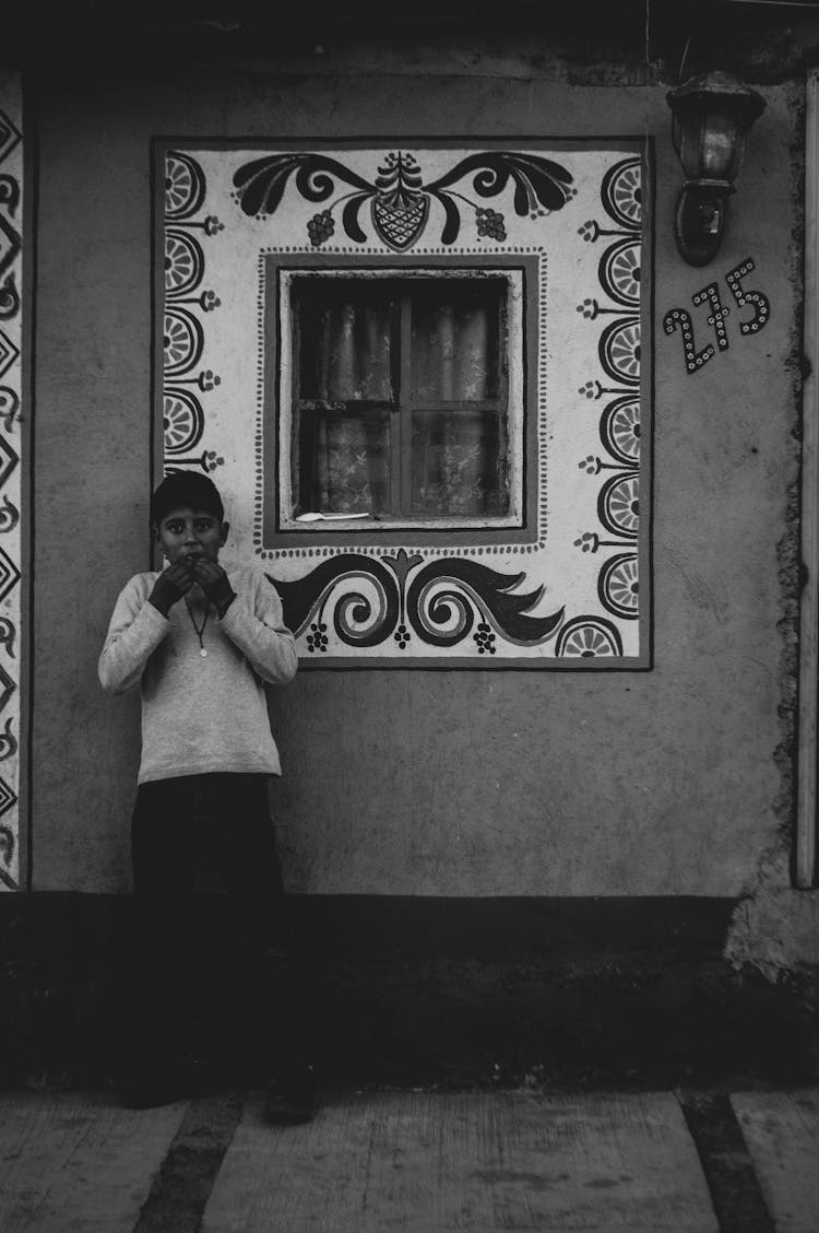 Kid Waiting Beside A Window