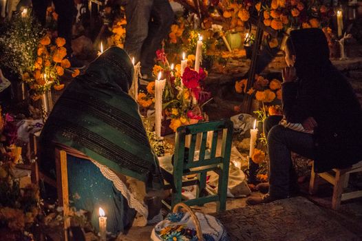 Vibrant candlelit Day of the Dead celebration with offerings in Janitzio, Mexico.