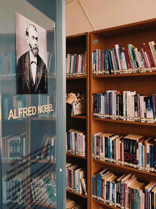 Books on Brown Wooden Shelf