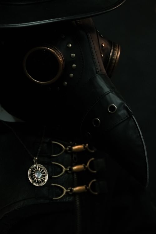 Free Close-up of a steampunk style plague doctor mask with intricate metallic detailing in a dramatic composition. Stock Photo