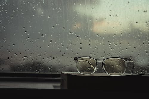 Free Eyeglasses on Top of a Book Stock Photo