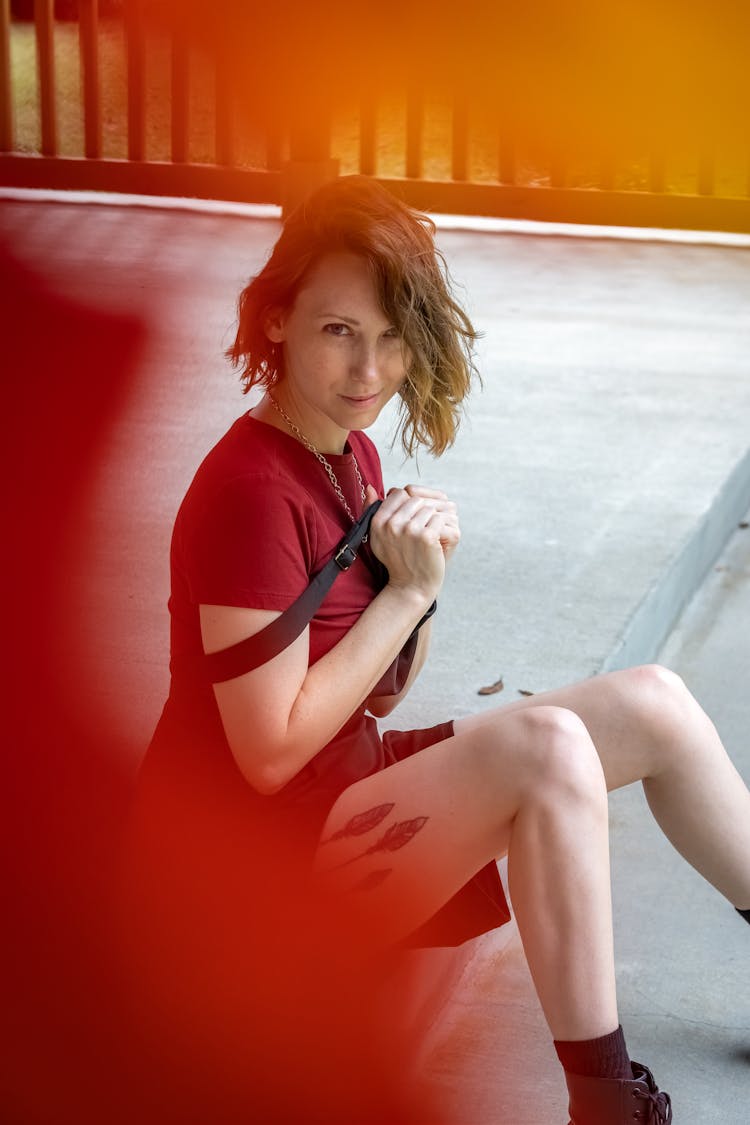 Woman In Red Dress With Leg Tattoo