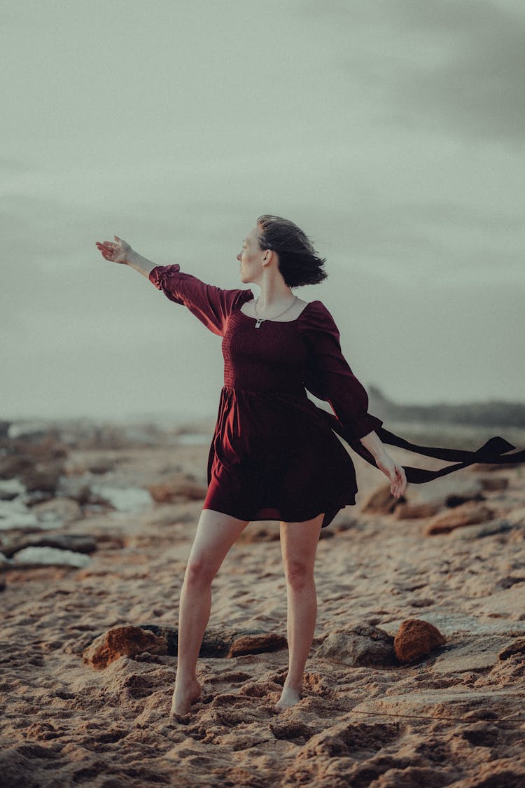 Woman In Maroon Dress In The Beach