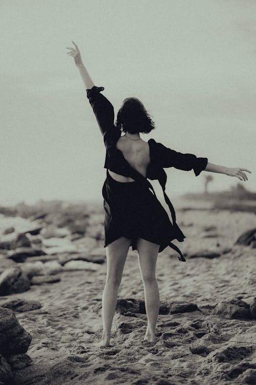 Woman Wearing a Dress Standing in the Beach