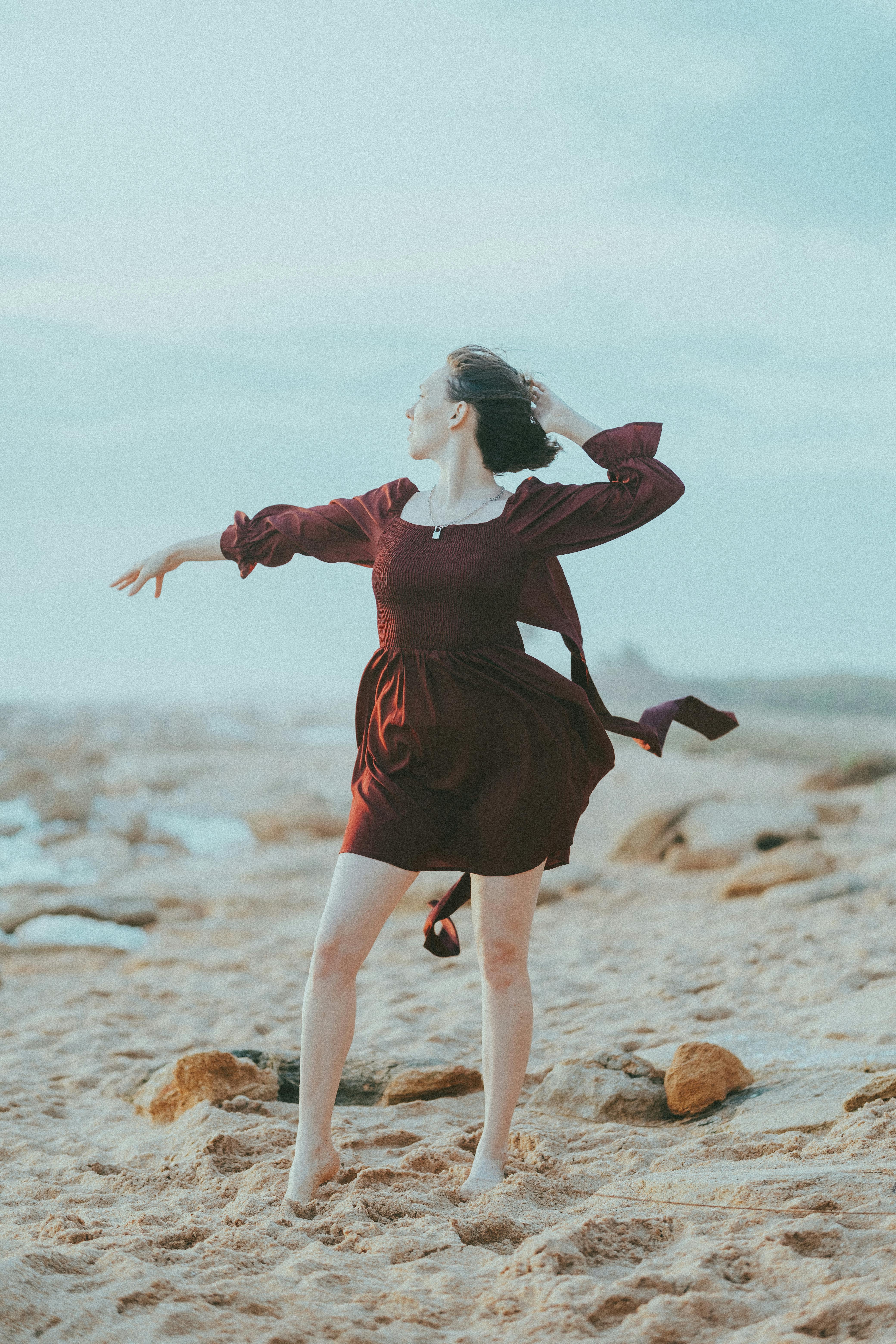 Woman in Maroon Dress in the Beach  Free Stock Photo