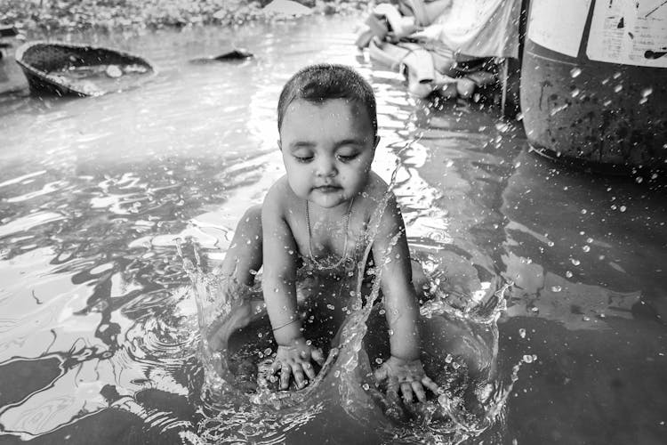 Shirtless Kid Playing With Water