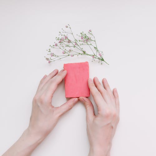 Hand Holding a Piece of Clay