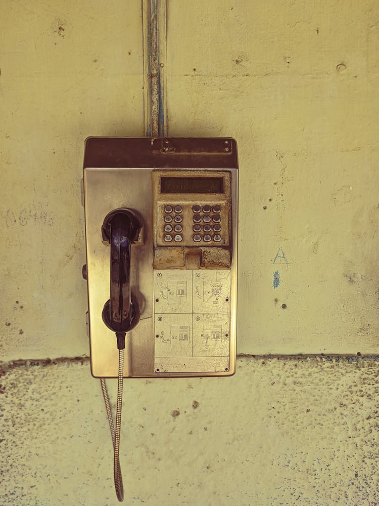 A Telephone Booth Hanging On The Wall