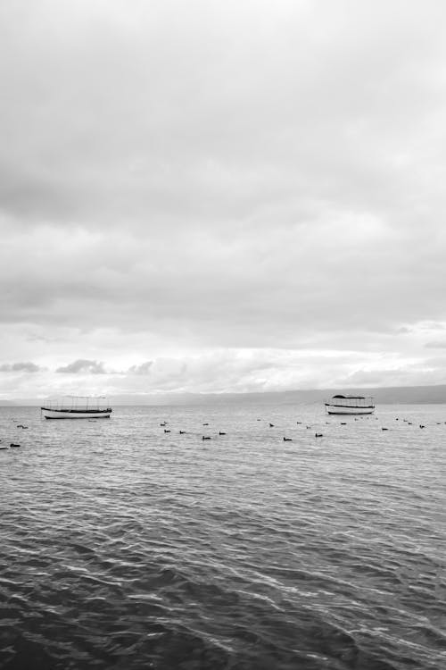 Grayscale Photo of Boats on Sea