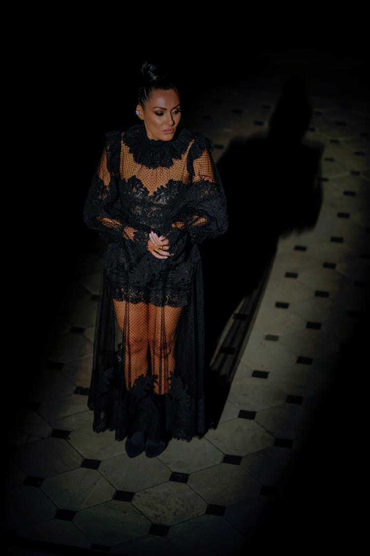 Woman In A Dress Standing On Tiled Floor