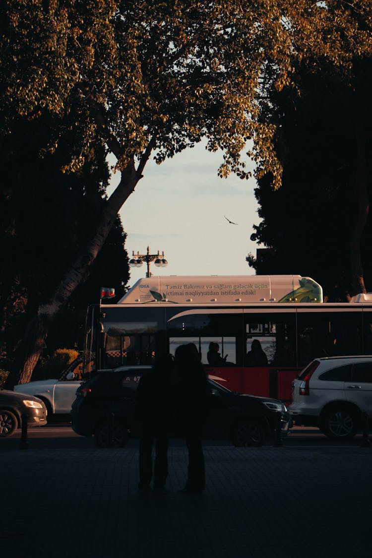 Busy City Street And Silhouettes Of People On The Sidewalk 