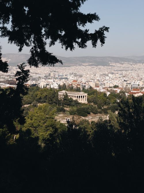 Free Panoramic view of Athens cityscape with ancient temple surrounded by greenery. Stock Photo