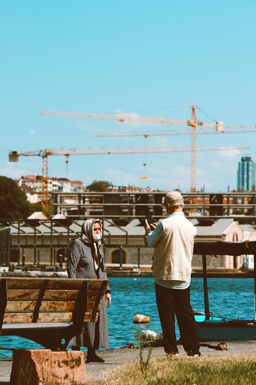 Elderly Man and Woman Standing by the Water 