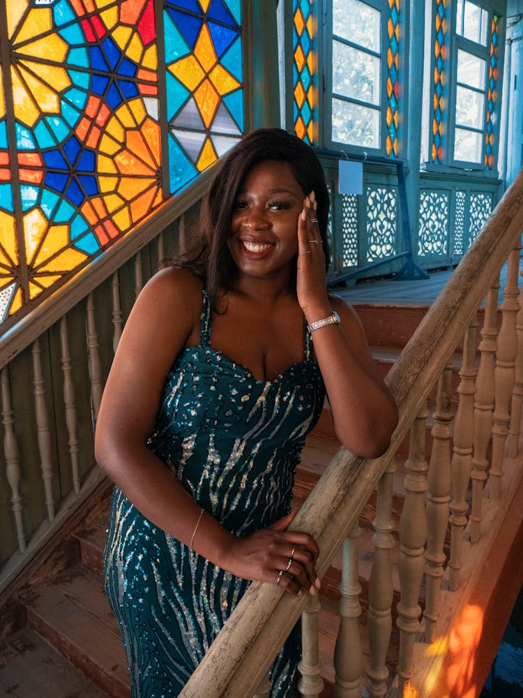 Elegant Young Woman Standing On Steps And Smiling 