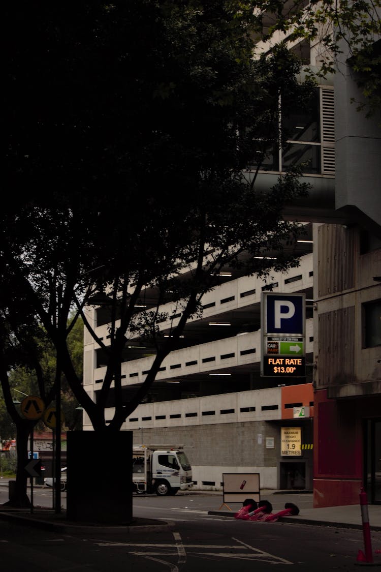 Building With Indoor Parking Sign In Dark