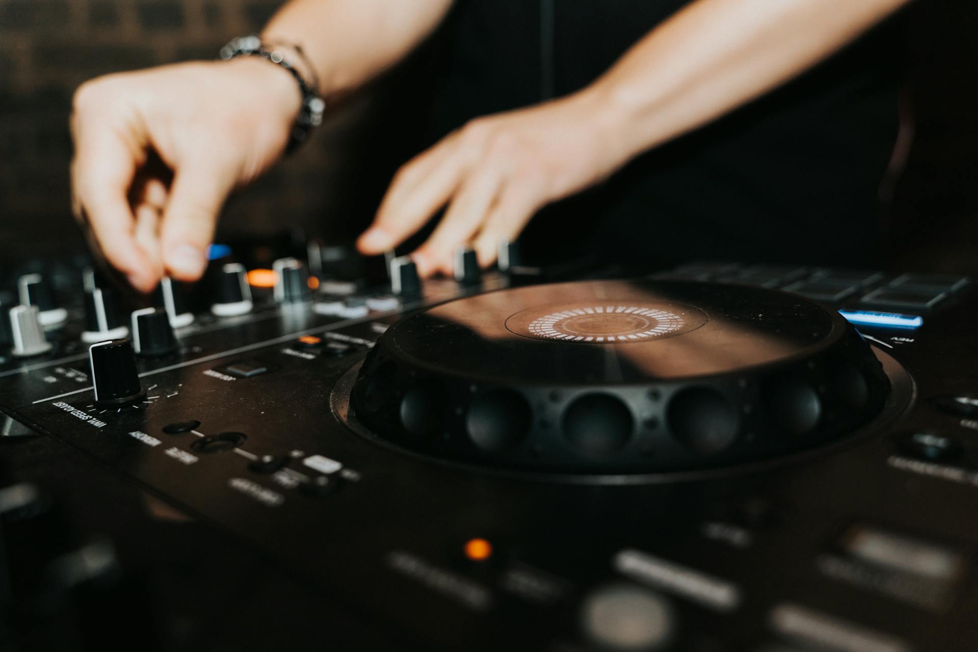 Close-up of DJ Playing on Mixer