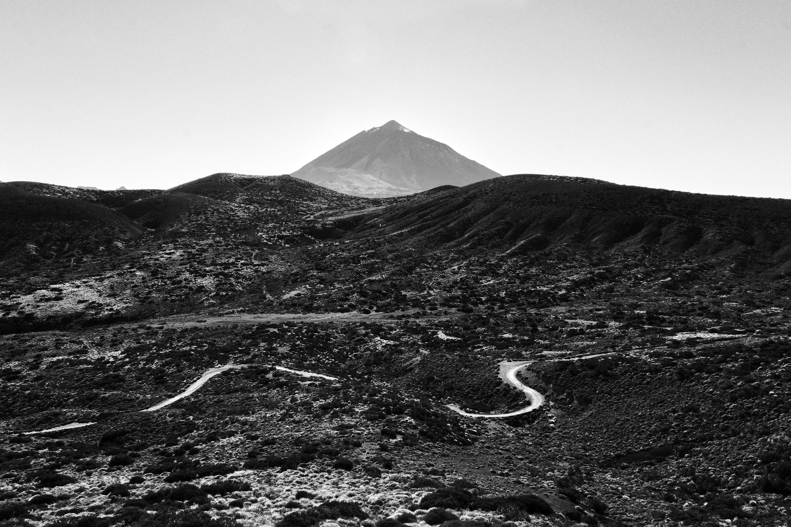 Breathtaking black and white shot of Mount Teide with rugged terrain, highlighting its majesty.