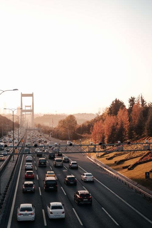 Free Aerial view of a bustling highway with heavy traffic and autumn foliage. Stock Photo