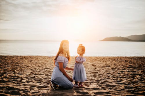 Free Woman and Girl by the Sea Stock Photo
