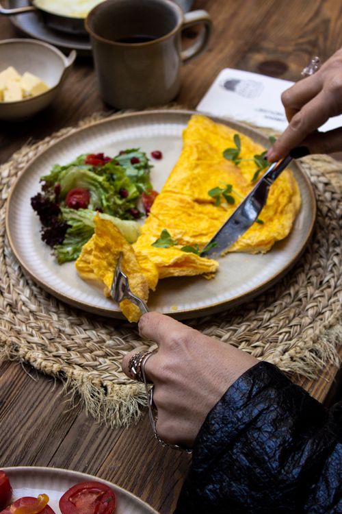 Free Enjoy a tasty omelette served with a fresh salad, perfect for a nutritious breakfast. Stock Photo