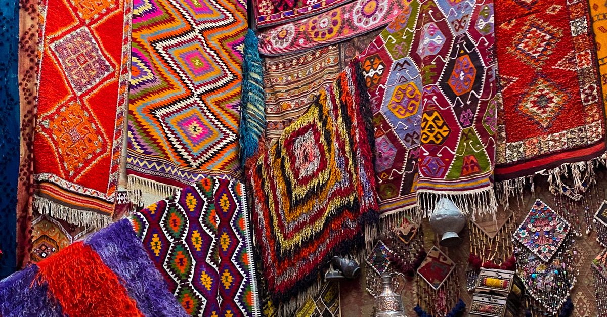 Native Textiles A Woman in Black Tank Top Sitting on Native Textiles · Free Stock Photo