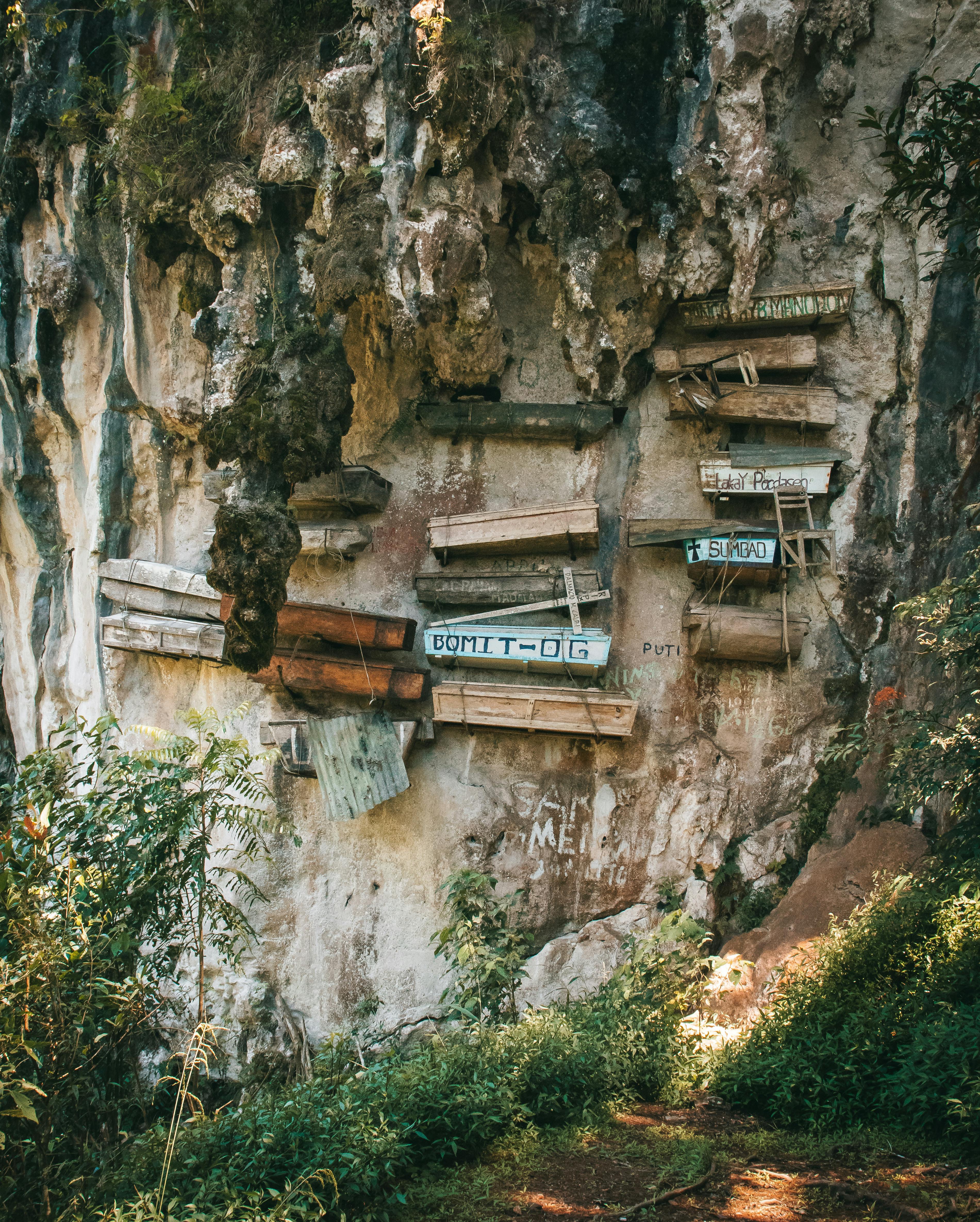 Explore the traditional hanging coffins of Sagada, Philippines, against limestone cliffs.