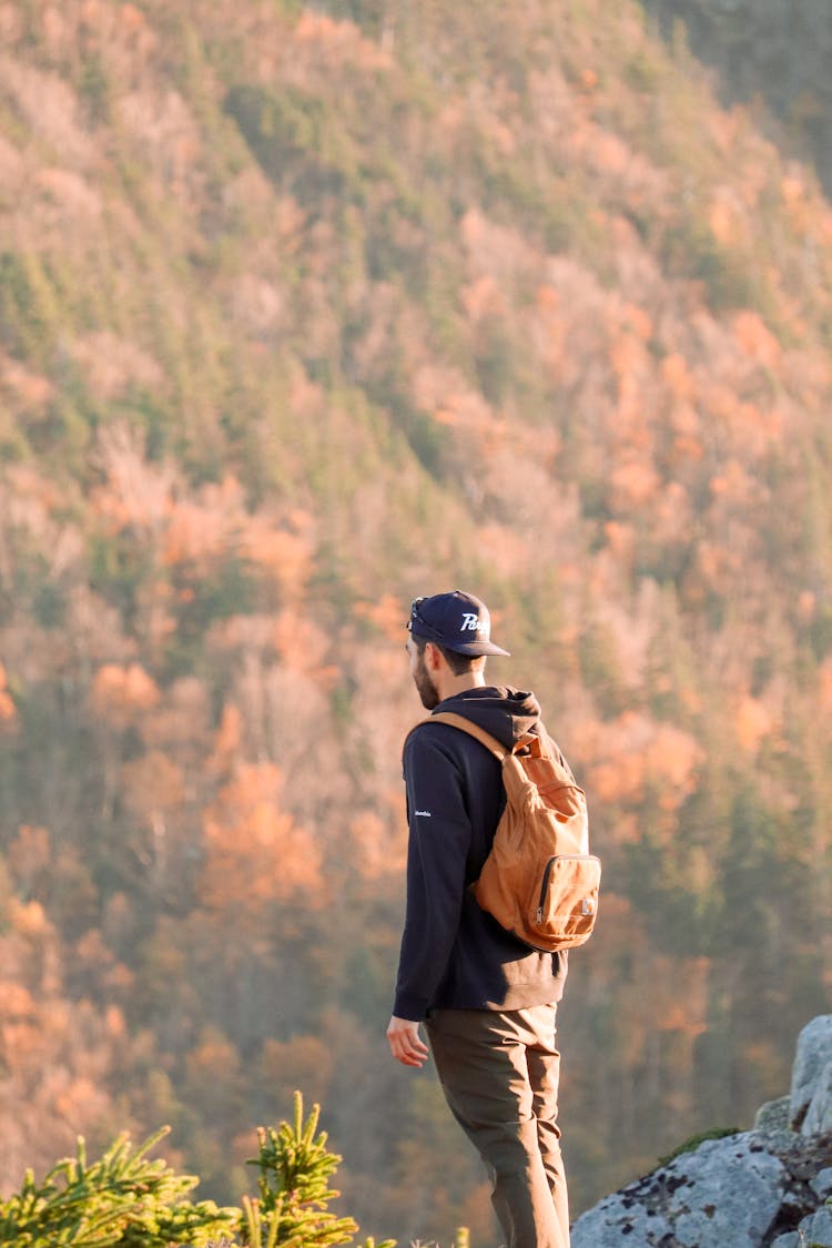 A Man In Black Jacket Standing On Mountain