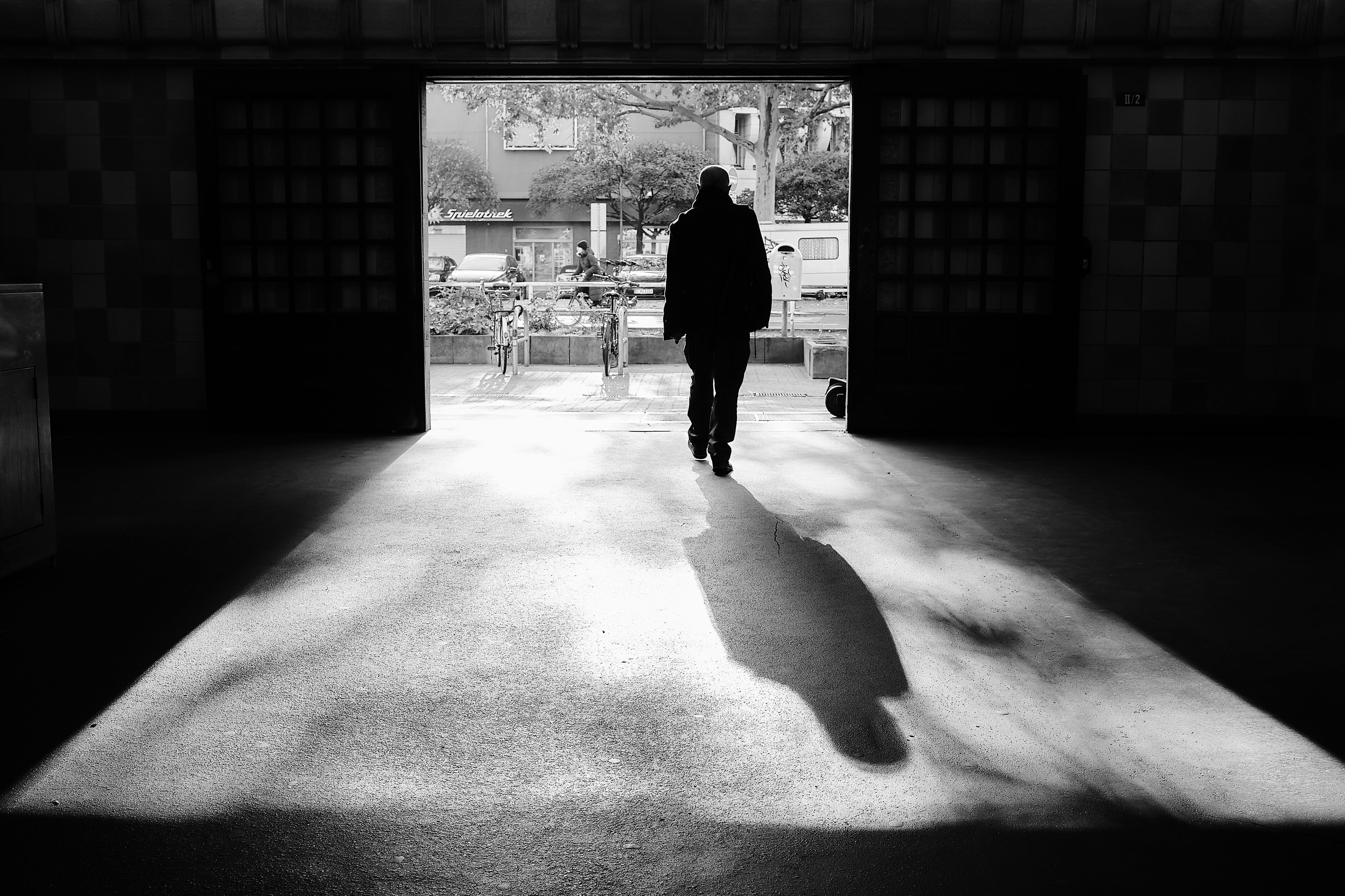 A solitary man in silhouette exits through a passageway in Berlin, Germany.