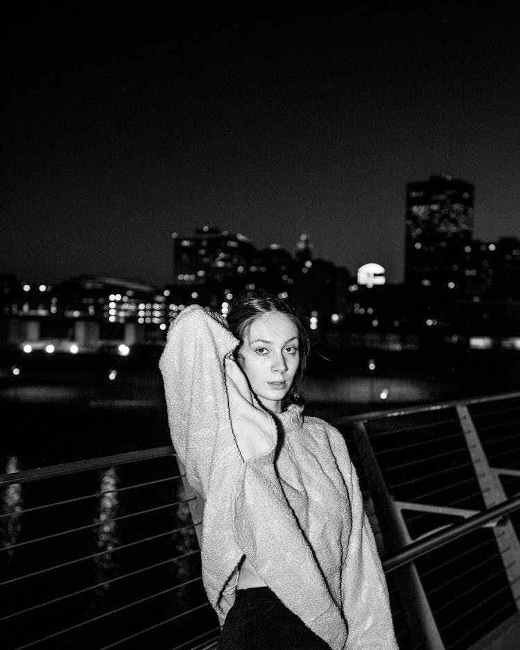 Black And White Photo Of Woman On Boat Against City Skyline