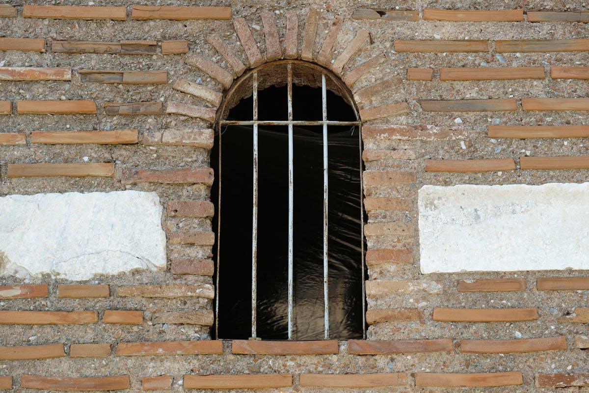 Person slicing bread carefully on a kitchen counter