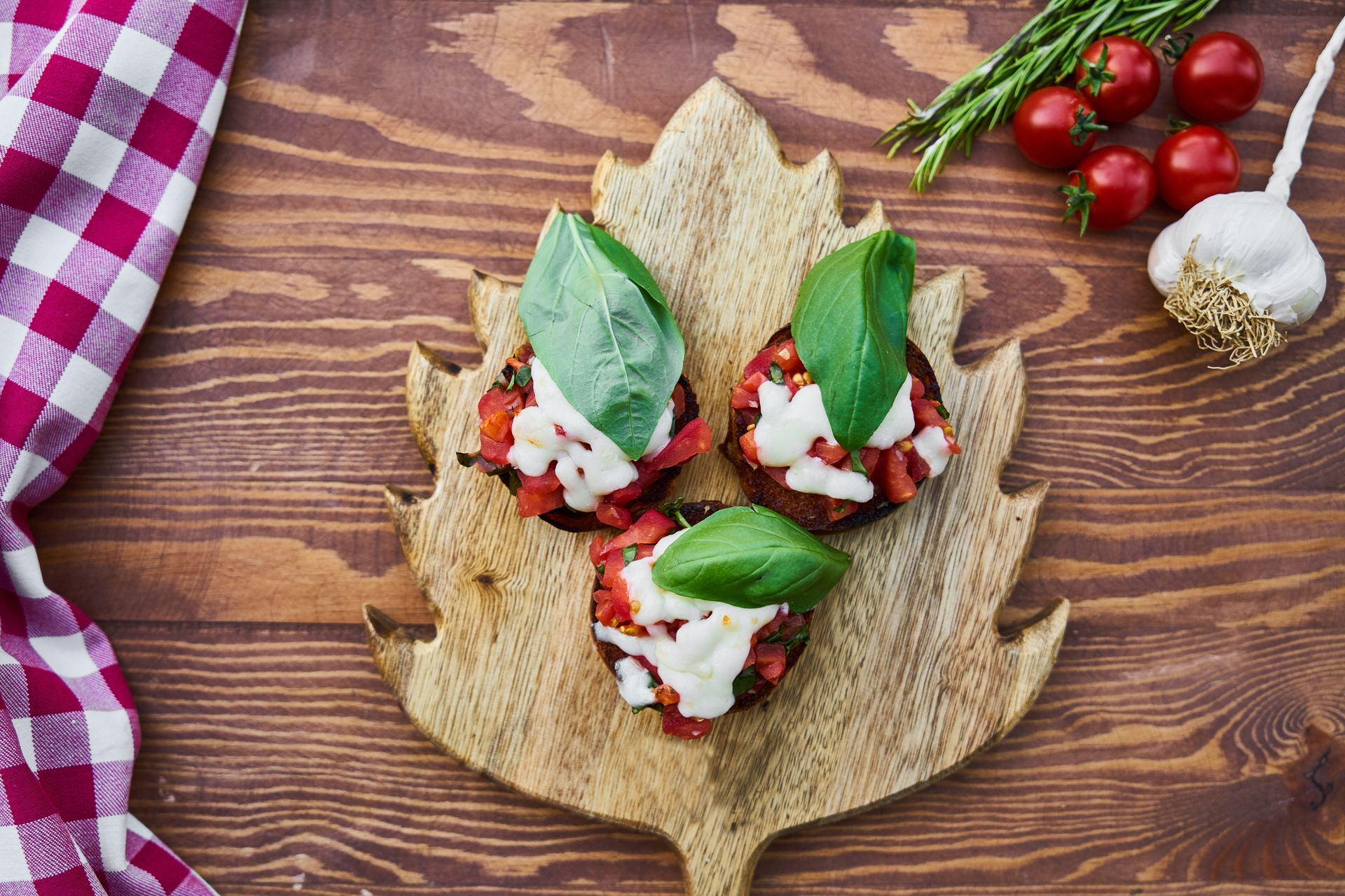Three Tomato Dishes on Brown Wooden Chopping Board