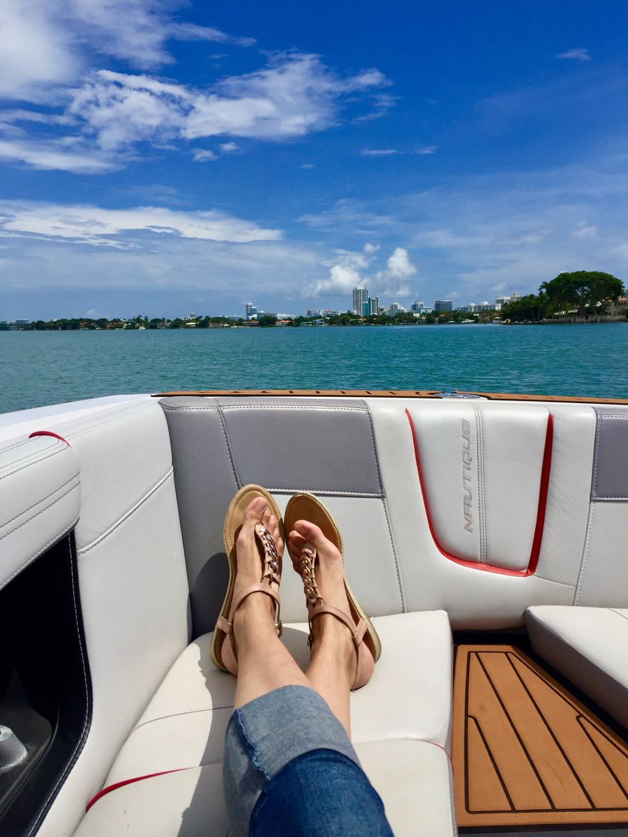 Feet relaxing in sandals near water