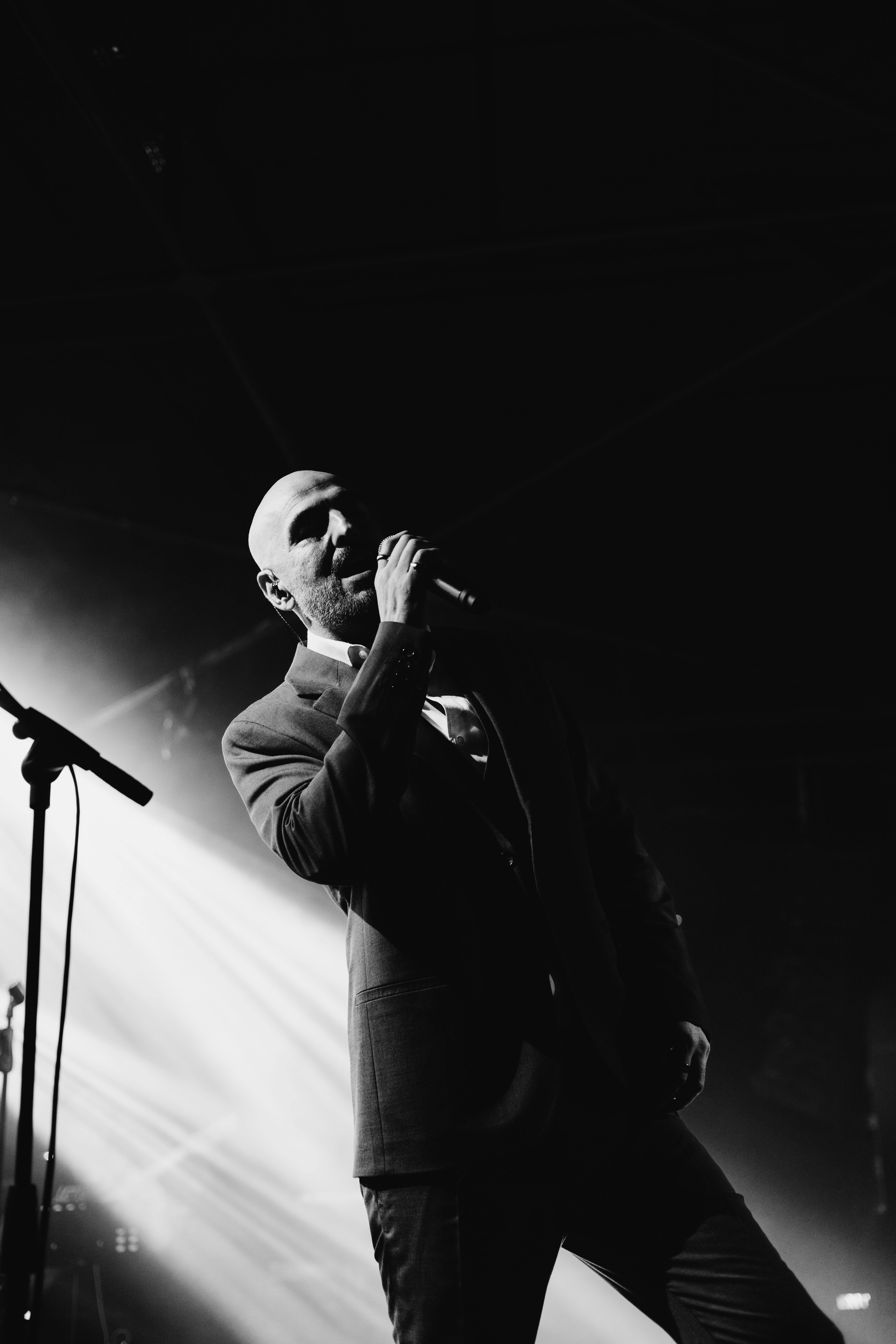 Grayscale Photo of a Singer Performing on Stage · Free Stock Photo