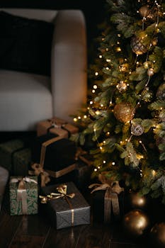 Cozy Christmas scene with a beautifully decorated tree and elegant wrapped presents around an armchair.