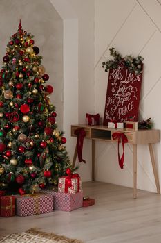 Cozy indoor setting featuring a beautifully decorated Christmas tree and gifts, capturing holiday spirit.