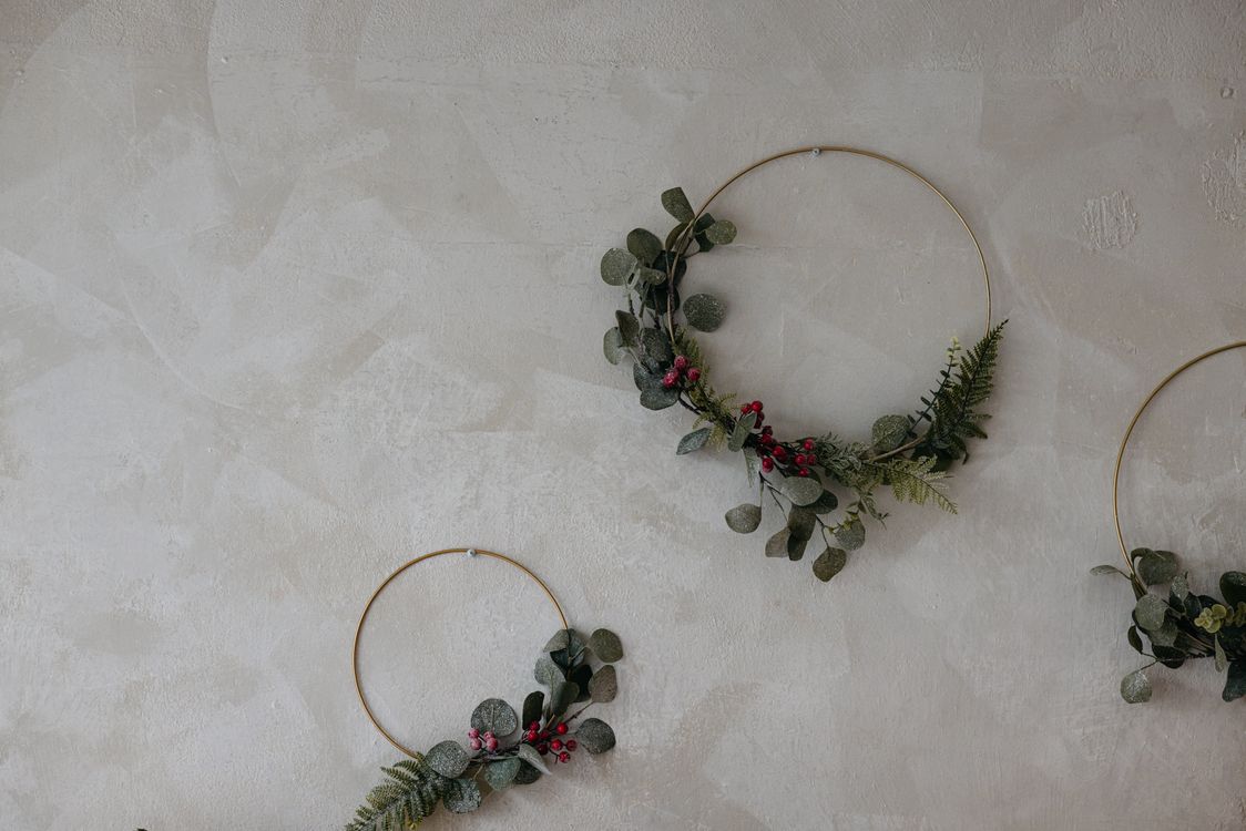 christmas-wall-decor Modern gold hoop Christmas wreaths with eucalyptus hanging on a wall