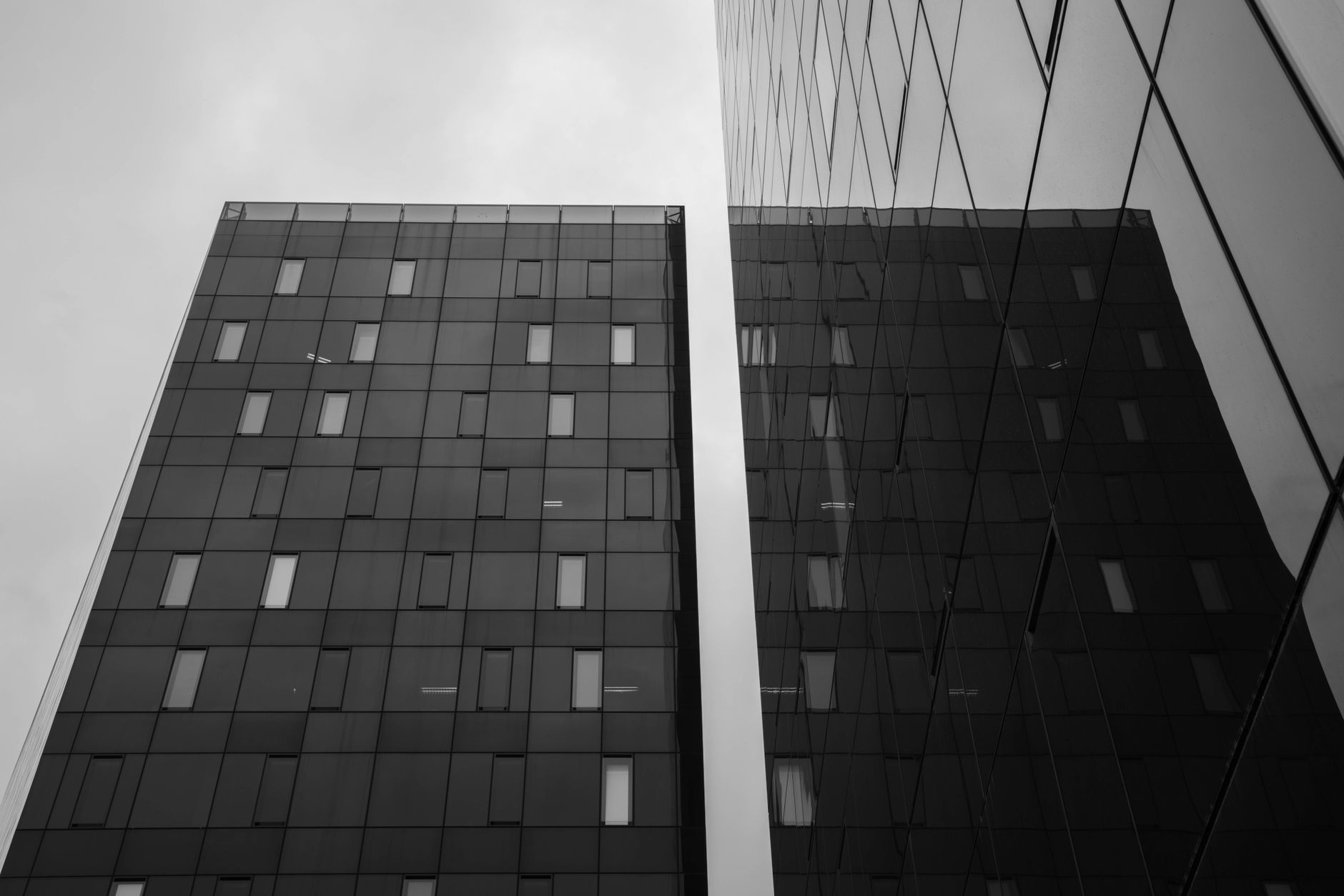 Monochrome view of modern high-rise buildings with geometric patterns.