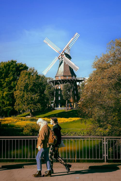 Women Walking on a Bridge with the Am Wall Windmill in the Background, Bremen, Germany