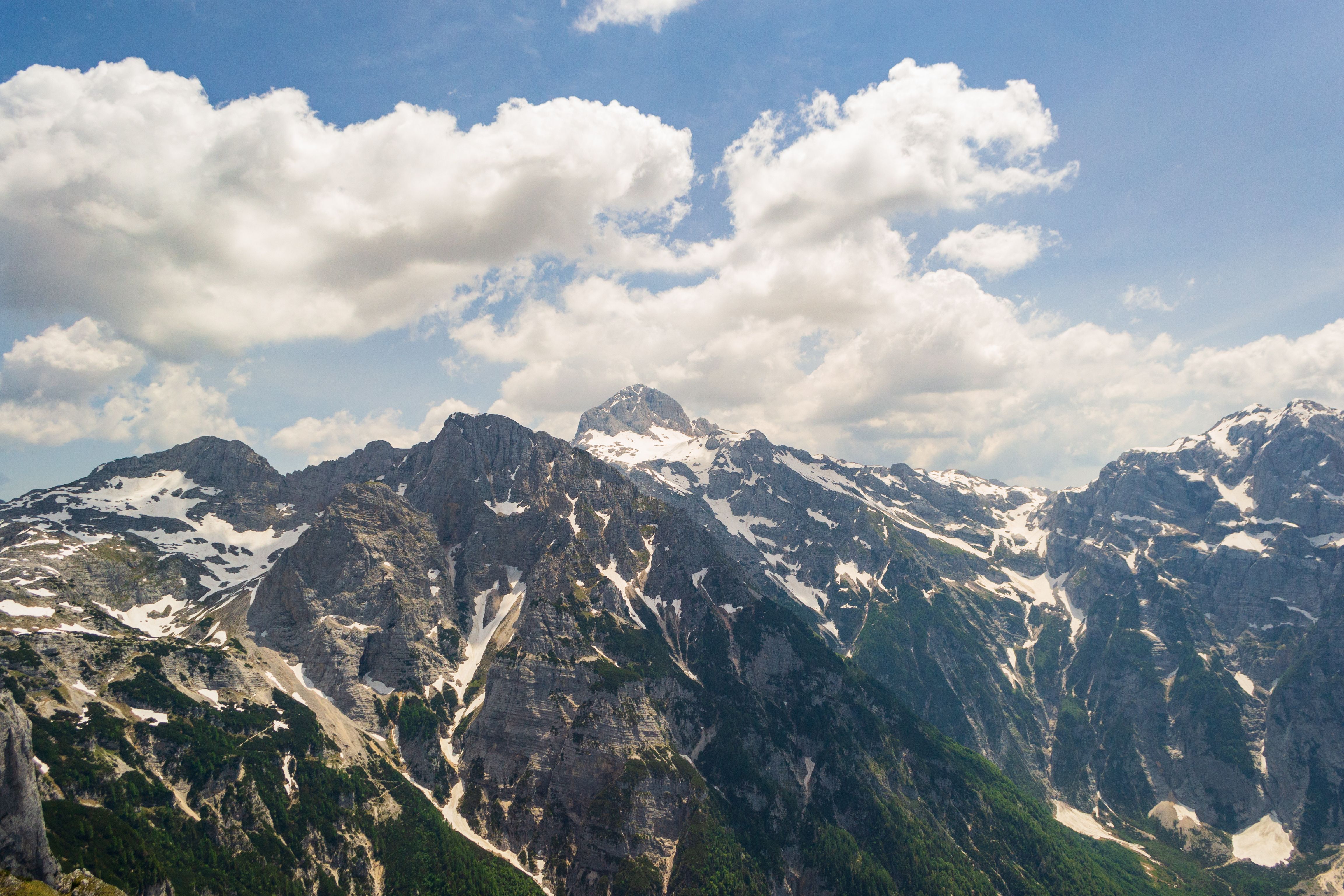 An Aerial Photography of Snow Covered Mountains Under the Blue Sky and ...