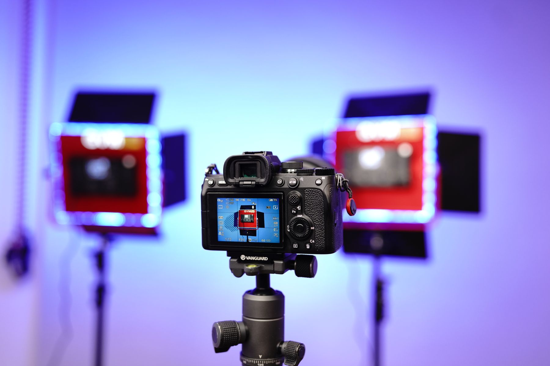 Black DSLR camera on tripod near studio light panels