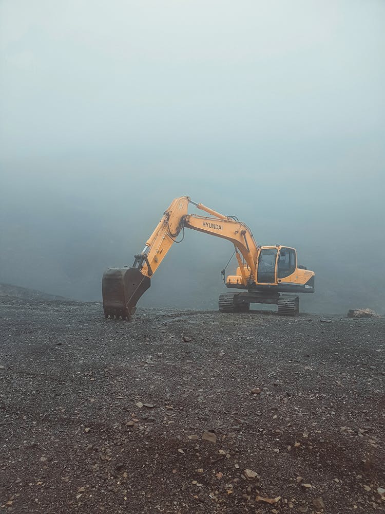 Excavator Working On Barren Ground