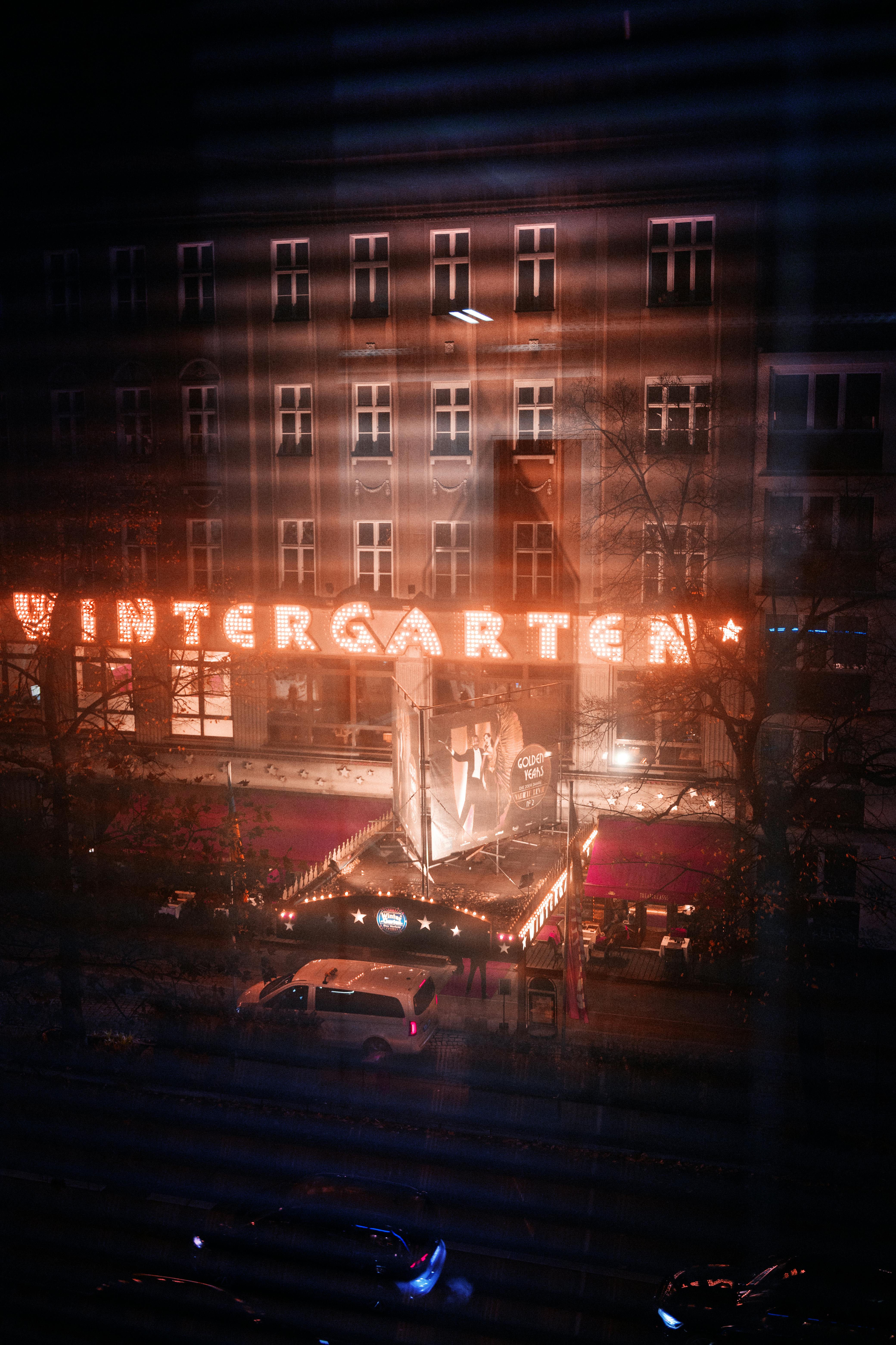 Free Night view of the iconic Wintergarten Theater in Berlin, beautifully illuminated and vibrant. Stock Photo