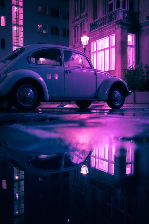 A Parked Volkswagen Beetle at Night