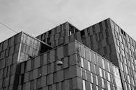 A Grayscale Photo of a Building Under the White Sky