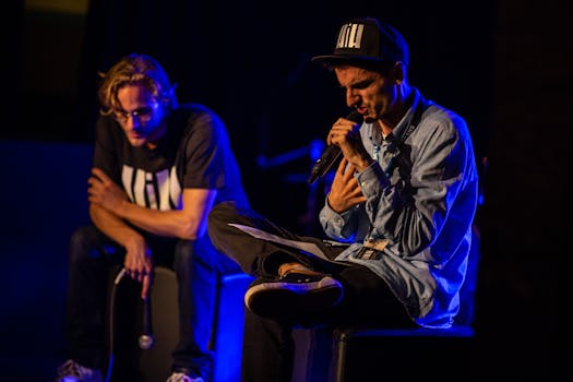 Two musicians performing energetically on stage under bright lights in Glarus, Switzerland.