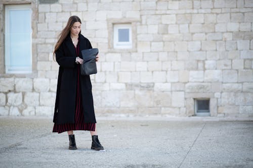 Model in Coat Holding Purse