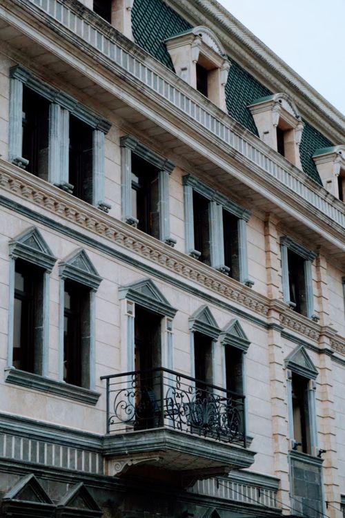 Free Elegant European architecture featuring ornate balconies and detailed façades. Stock Photo